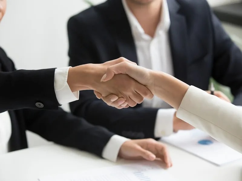 Strategic partnership handshake symbolising trusted advisory